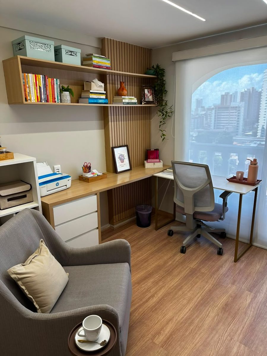 Mesa de trabalho e estante de livros do consultório
